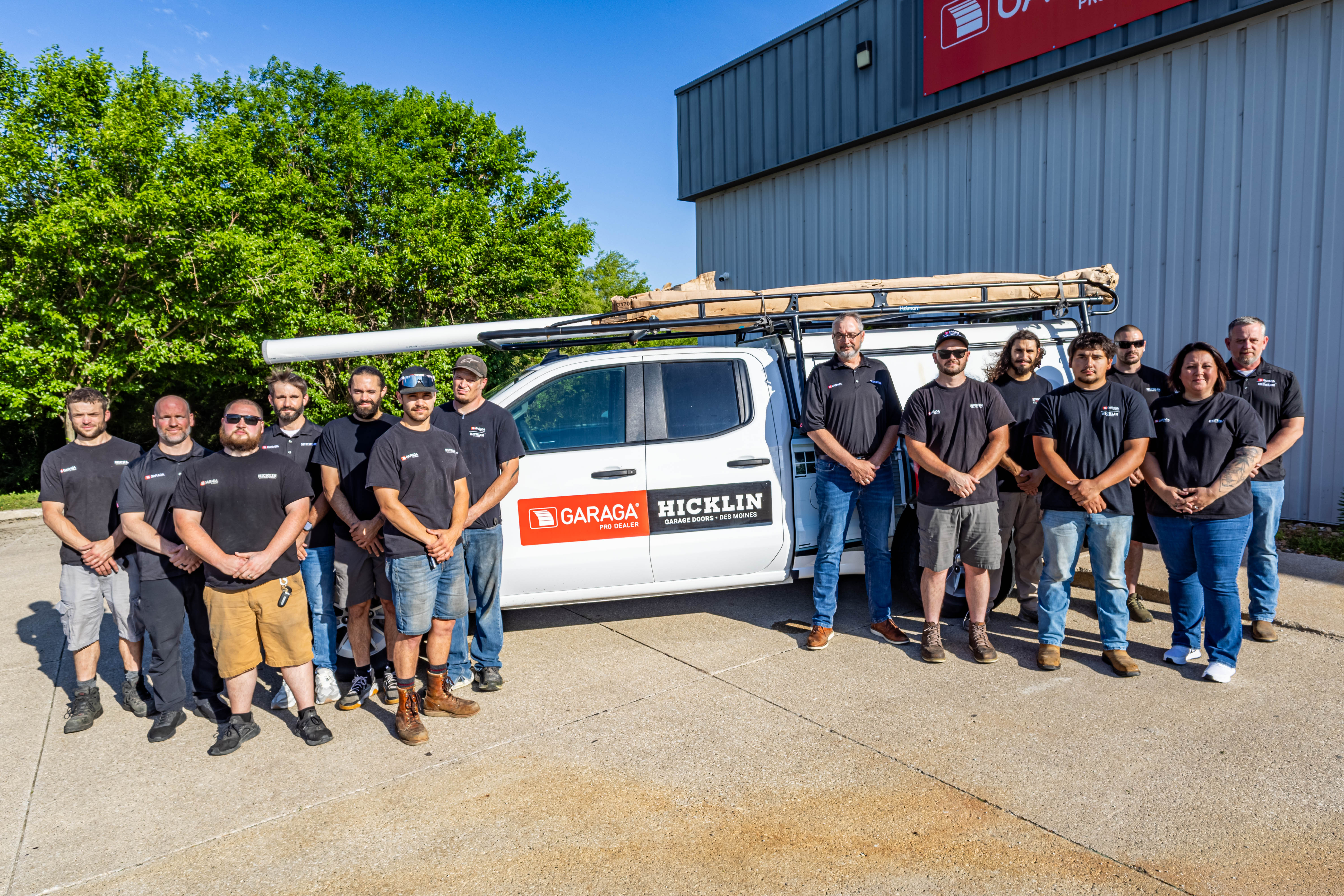 Employees of Hicklin Garage Door Services standing in front of their service truck.