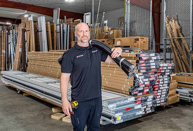 Hicklin Garage Door Des Moines installer with spring on his shoulder