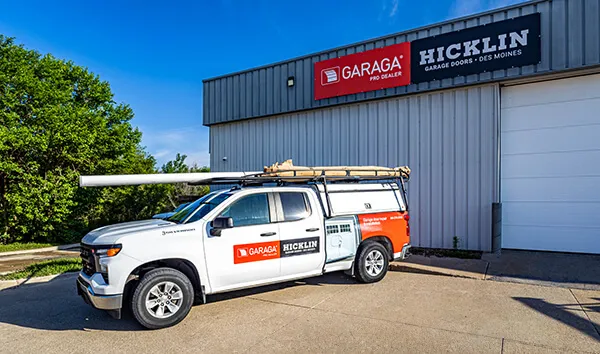 Hicklin Garage Door Des Moines service truck in front of a commercial building