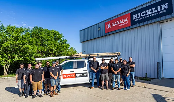 Garage door specialist team in front of a service truck